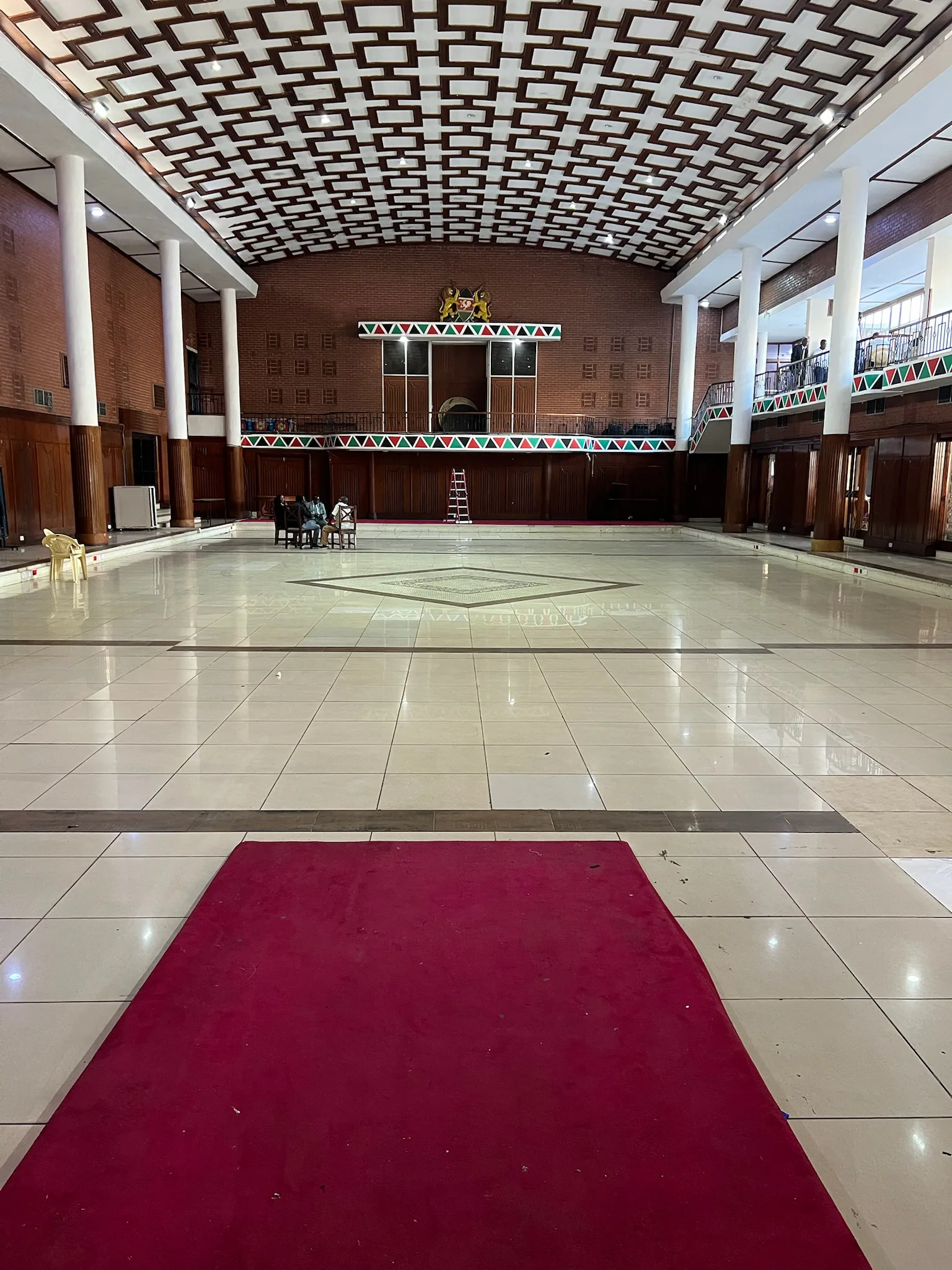 The large interior of Charter Hall stands nearly empty while preparations are underway the night before the conference.